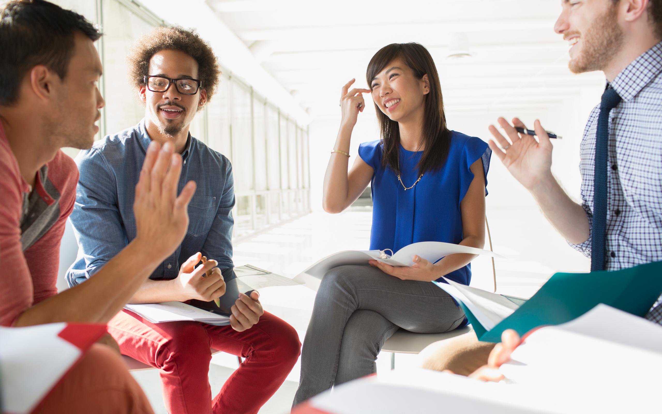 Business people meeting in circle of chairs