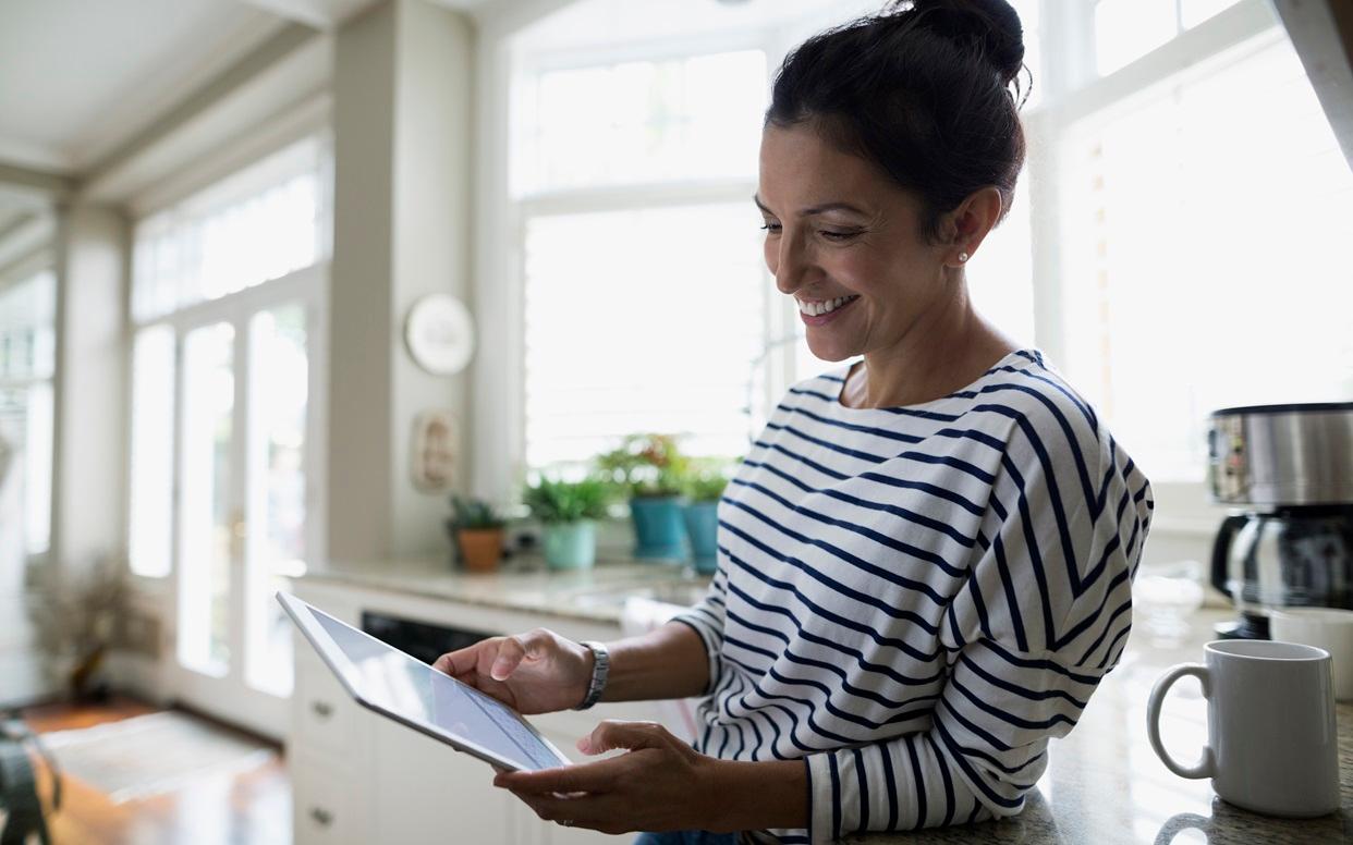 Smiling woman holding a tablet