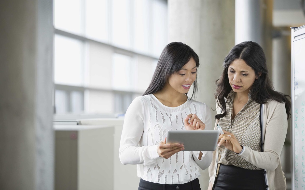 Businesswomen looking at digital tablet