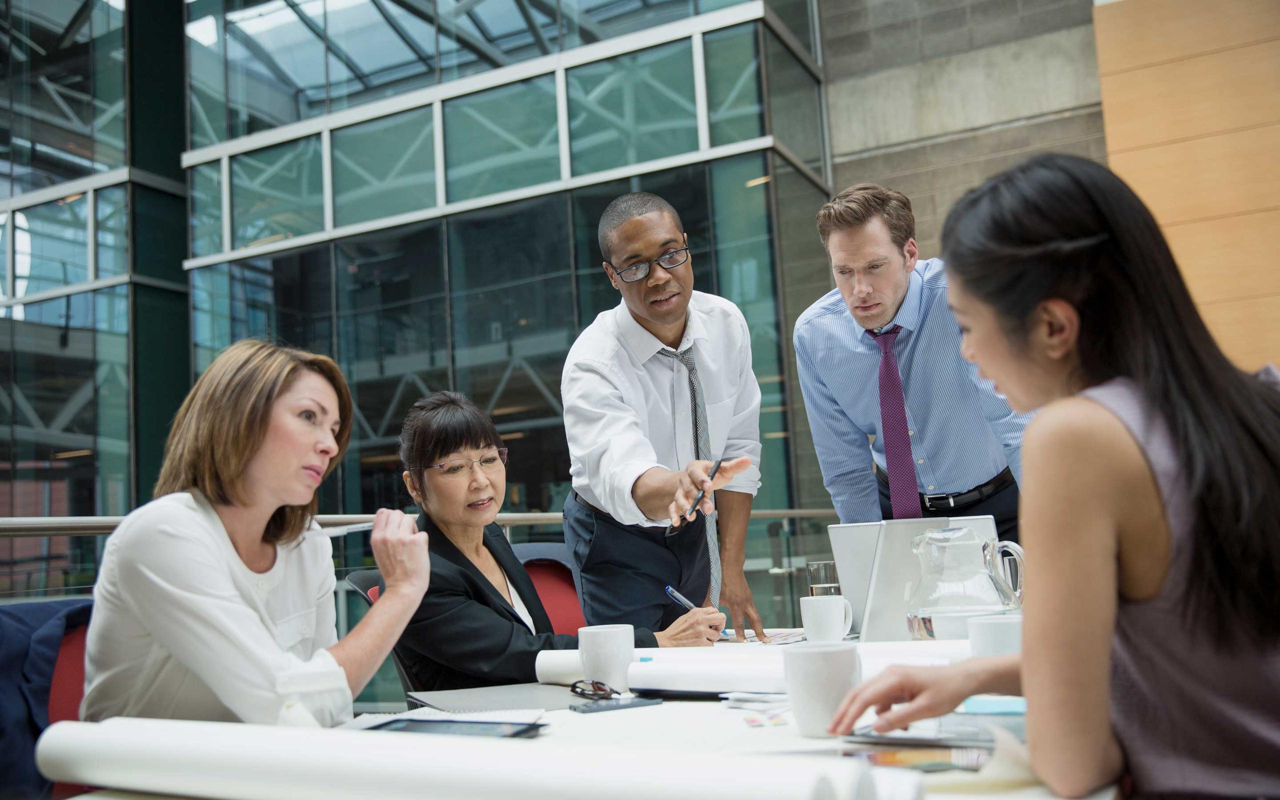 Business people discussing documents in conference room