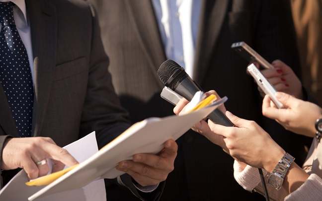 People holding microphones and papers